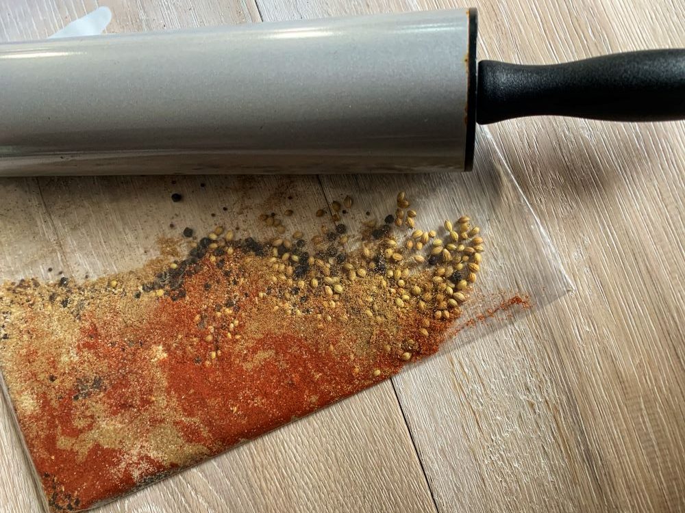 crushing spices with a rolling pin